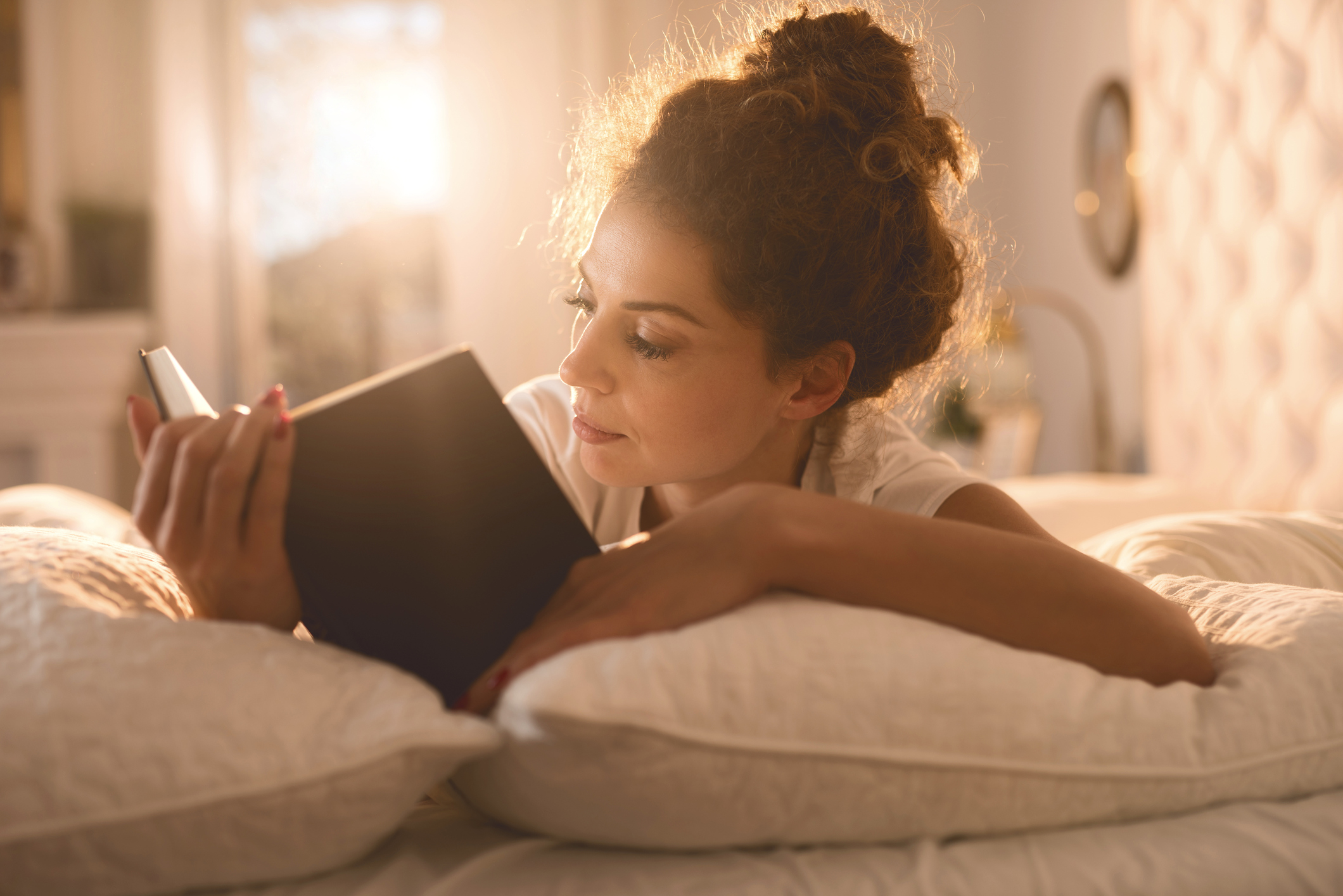 Relaxed Woman Reading A Book In Her Bed Humanitas Salute